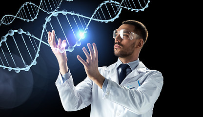 Image showing scientist in lab coat and safety glasses with dna