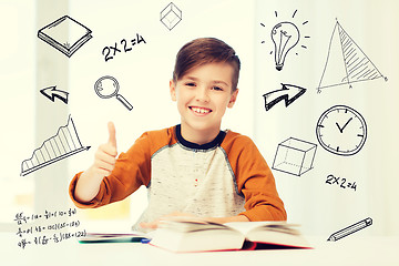 Image showing happy student boy with textbook showing thumbs up