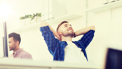 Image showing happy creative man with computer at office