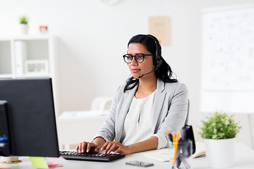 Image showing businesswoman with headset and computer at office