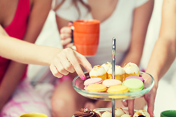 Image showing friends or teen girls eating sweets at home