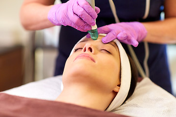 Image showing woman having microdermabrasion facial treatment