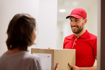 Image showing happy delivery man giving parcel box to customer