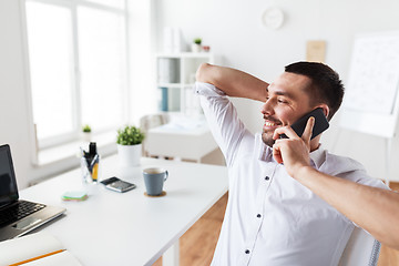 Image showing businessman calling on smartphone at office