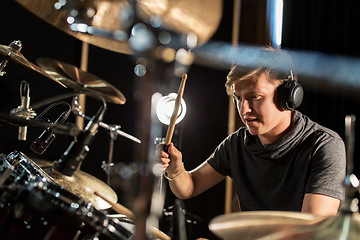 Image showing male musician playing drums and cymbals at concert