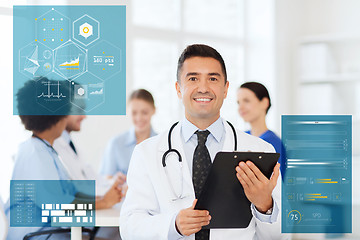 Image showing happy doctor with clipboard over medical team