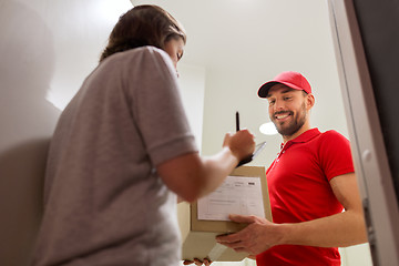 Image showing deliveryman and customer with parcel boxes at home