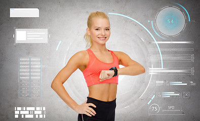 Image showing happy sporty young woman with fitness tracker