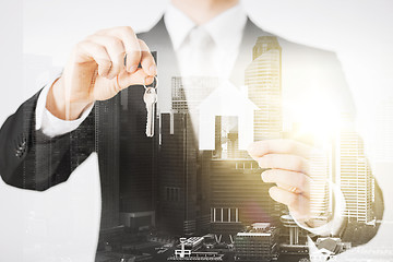 Image showing close up of businessman holding keys and house