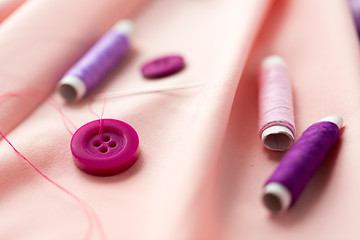 Image showing sewing buttons, spools of thread and cloth