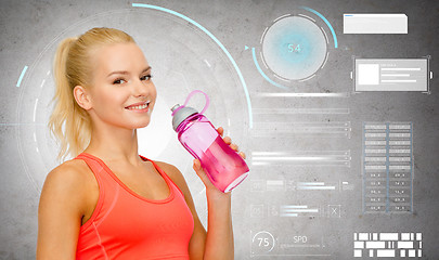 Image showing smiling sporty woman with water bottle