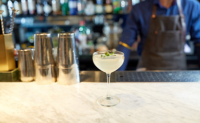 Image showing bartender and glass of cocktail at bar