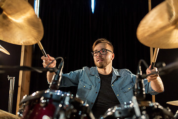 Image showing male musician playing drums and cymbals at concert