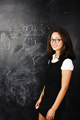 Image showing portrait of happy cute student in classroom at blackboard back t