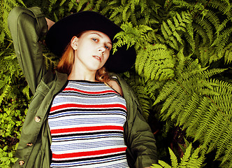 Image showing Pretty young blond girl hipster in hat among fern, vacation in green forest, lifestyle fashion people concept