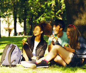 Image showing cute group of teenages at the building of university with books 