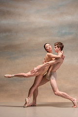 Image showing Couple of ballet dancers posing over gray background