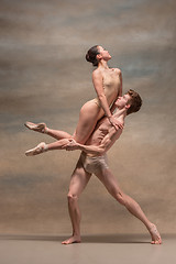 Image showing Couple of ballet dancers posing over gray background