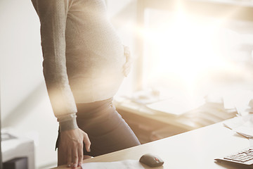 Image showing pregnant businesswoman with computer at office