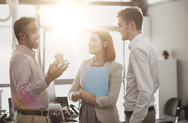 Image showing happy business team drinking coffee at office