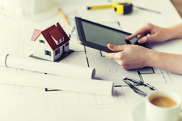 Image showing close up of hand with blueprint and tablet pc