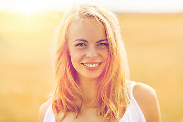 Image showing smiling young woman in white on cereal field