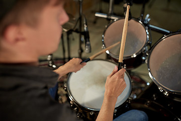 Image showing man playing drums at concert or music studio