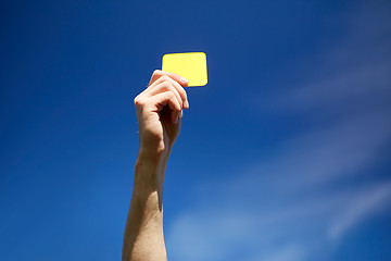 Image showing referee on football field showing yellow card