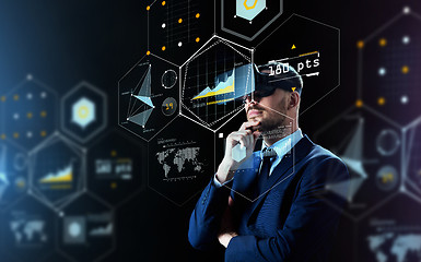 Image showing businessman in virtual reality headset over black