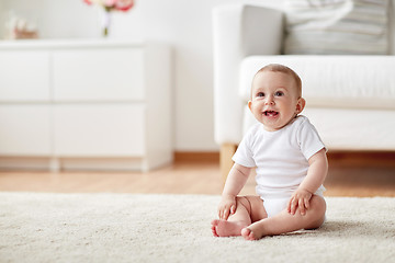 Image showing happy baby boy or girl sitting on floor at home