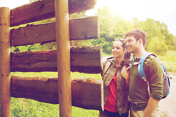 Image showing smiling couple with backpacks hiking