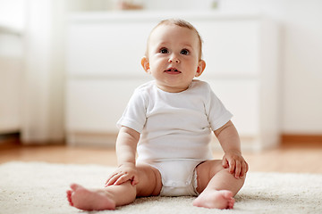 Image showing happy baby boy or girl sitting on floor at home