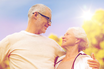 Image showing senior couple hugging in city park