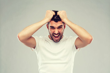 Image showing crazy shouting man in t-shirt over gray background