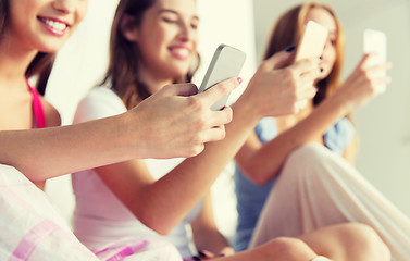 Image showing friends or teen girls with smartphones at home