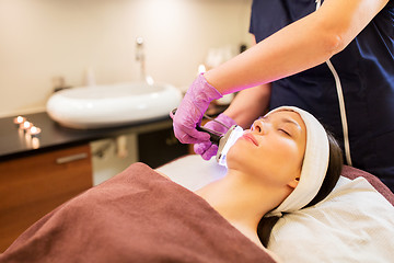 Image showing young woman having face microdermabrasion at spa