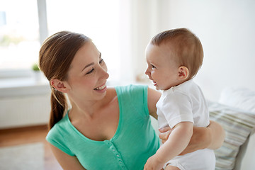 Image showing happy young mother with little baby at home