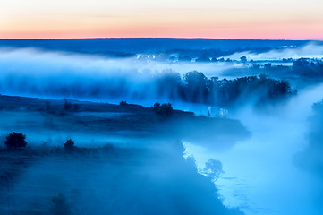 Image showing Foggy sunrise on river