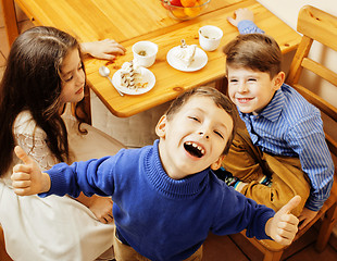 Image showing little cute boys eating dessert on wooden kitchen. home interior. smiling adorable friendship together forever friends, lifestyle people concept 