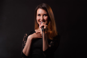 Image showing Brunette in dress with microphone