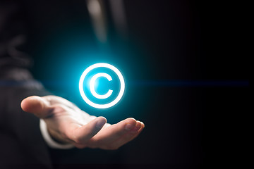 Image showing Man holds patent mark ,copyright