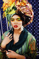 Image showing beauty bright woman with creative make up, many shawls on head l