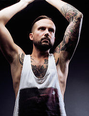 Image showing A man with tattooes on his arms. Silhouette of muscular body. caucasian brutal hipster guy with modern haircut, looking like criminal