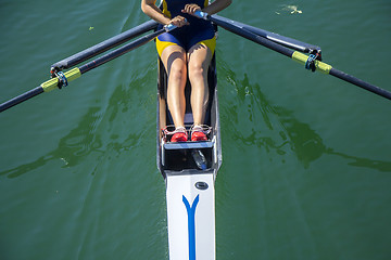 Image showing A young girl rowing in boat on water