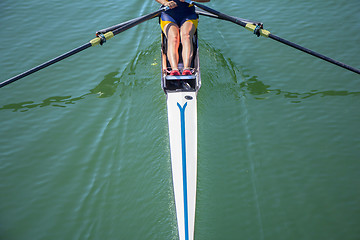 Image showing A young girl rowing in boat on water