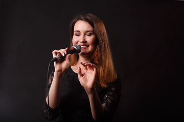 Image showing Singing brunette on empty background