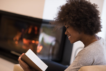 Image showing black woman at home reading book