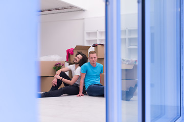 Image showing young  gay couple moving  in new house