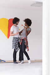 Image showing couple with painted heart on wall