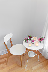 Image showing Elegant white interior with candle lights and spring flowers